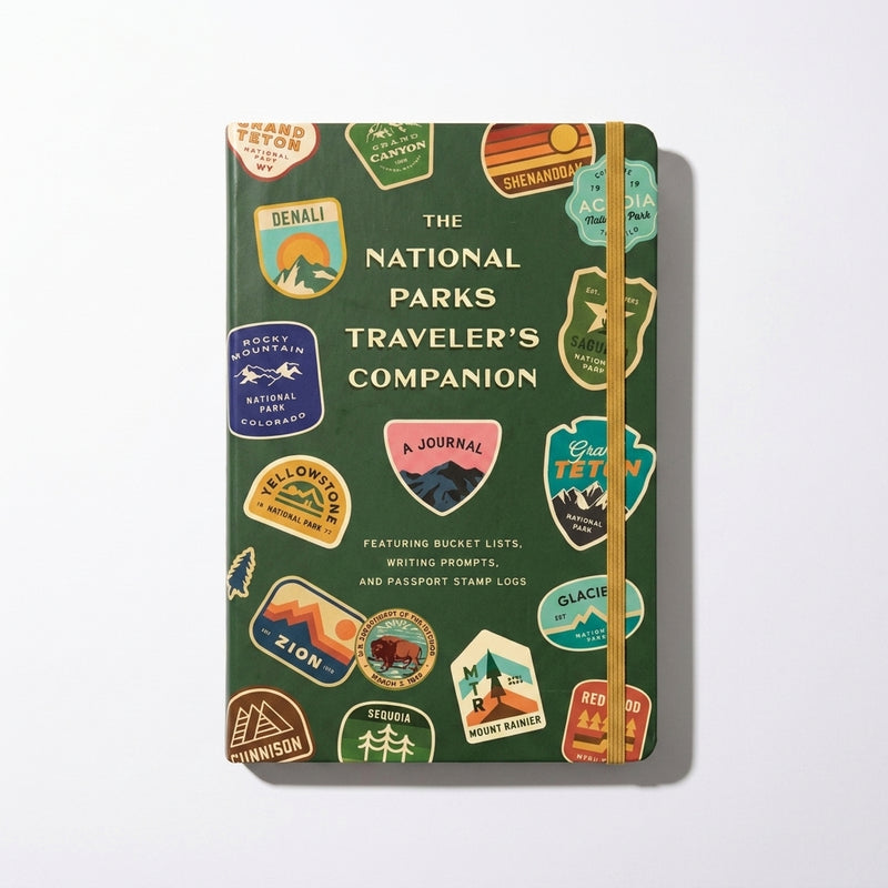 Penguin Random House National Parks Traveler's Companion journal, dark green cover with colorful park badges and yellow…