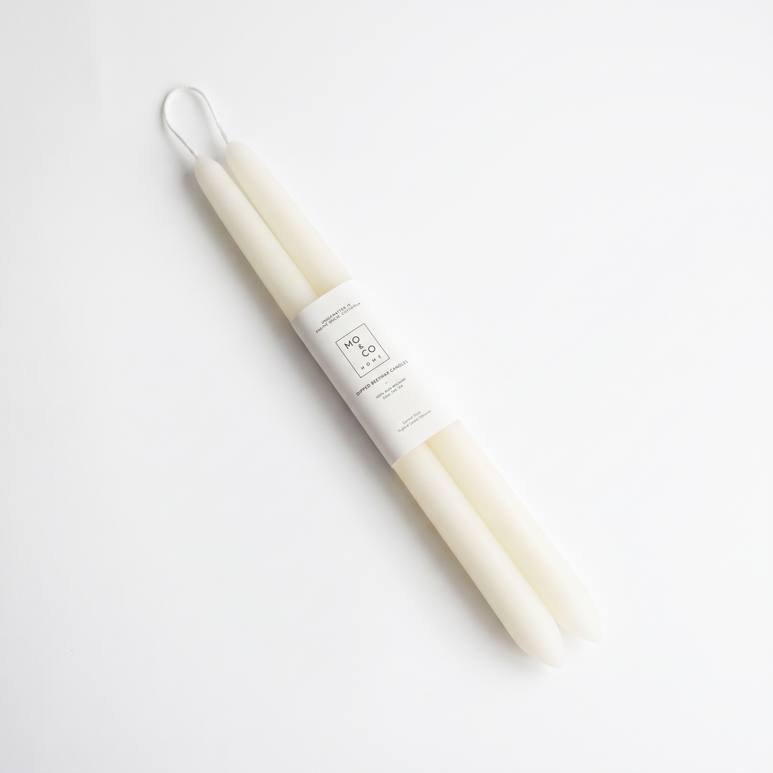 Mo&Co Home Natural White Dipped Beeswax Taper Candles studio product photo on a neutral off-white background