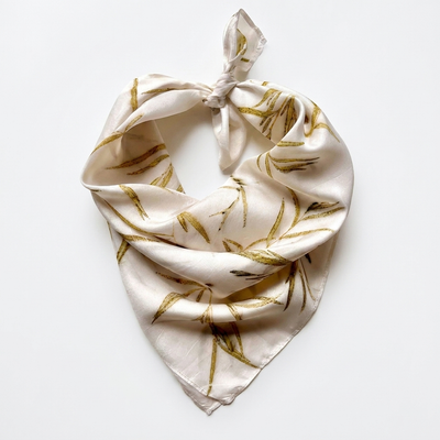 
                    
                      Vive Textiles Eucalyptus Grove silk bandana scarf, knotted flat lay on white, featuring eco-printed feather eucalyptus…
                    
                  