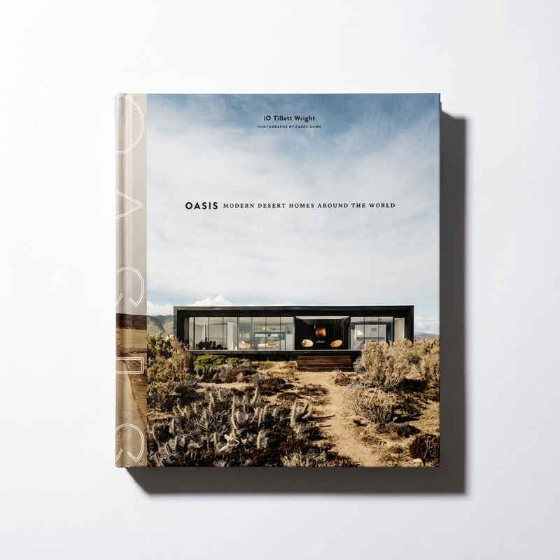 Penguin Random House Oasis book, cover featuring a modern black desert home under a blue sky, front view on white.