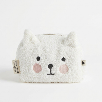 
                    
                      Sylvie Thiriez Petit Coeur Children's Toiletry Bag studio product photo hanging from a wooden wall hook on a neutral…
                    
                  