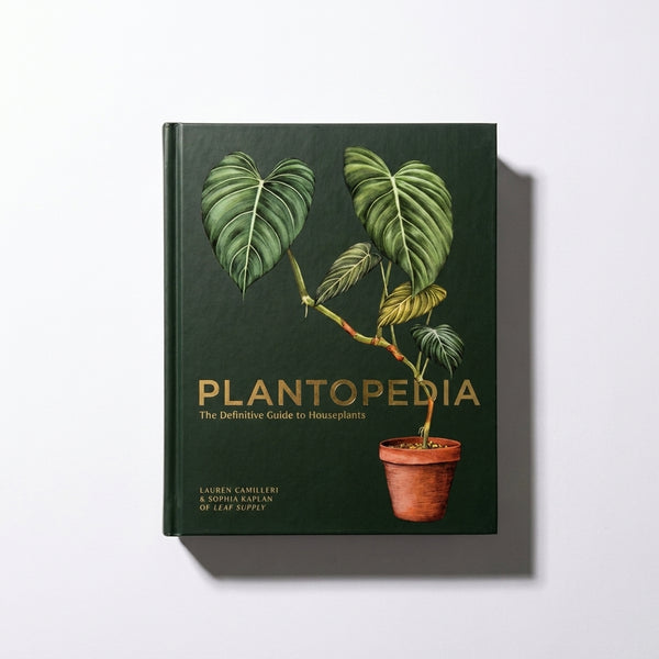 Penguin Random House Plantopedia hardcover book, dark green cover with gold foil title and detailed plant illustration,…