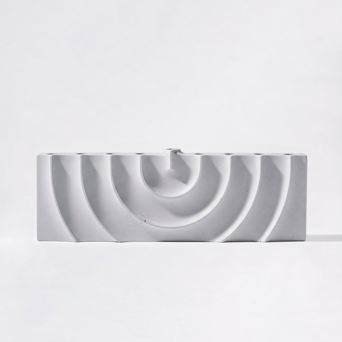 Logifaces Ripple Concrete Menorah studio product photo on a neutral off-white background