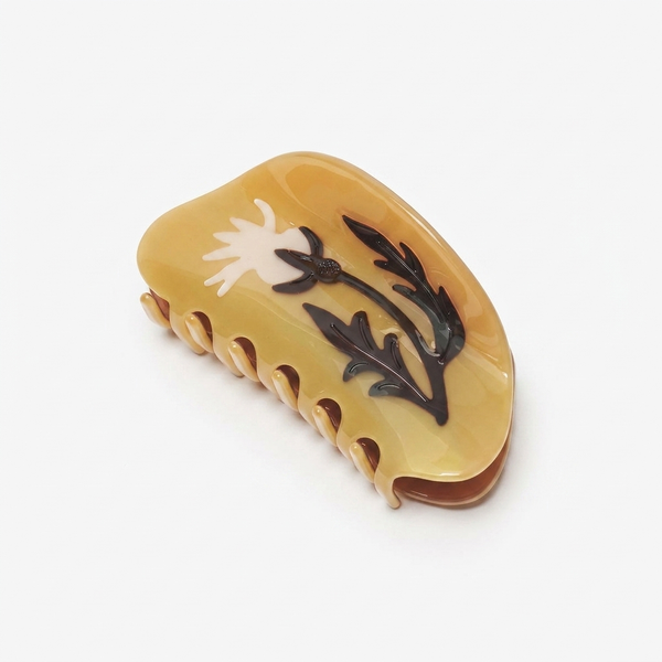 WINONA IRENE Rosehip Hair Claw, amber cellulose acetate hair clip with cream and dark brown flower design, angled view on…