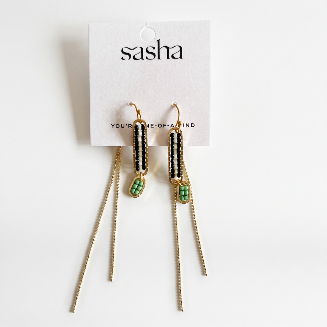 Sasha Stripe Beaded Earrings, indigo/black, white, mint seed beads, gold oval frame, chain fringe, on brand display card.