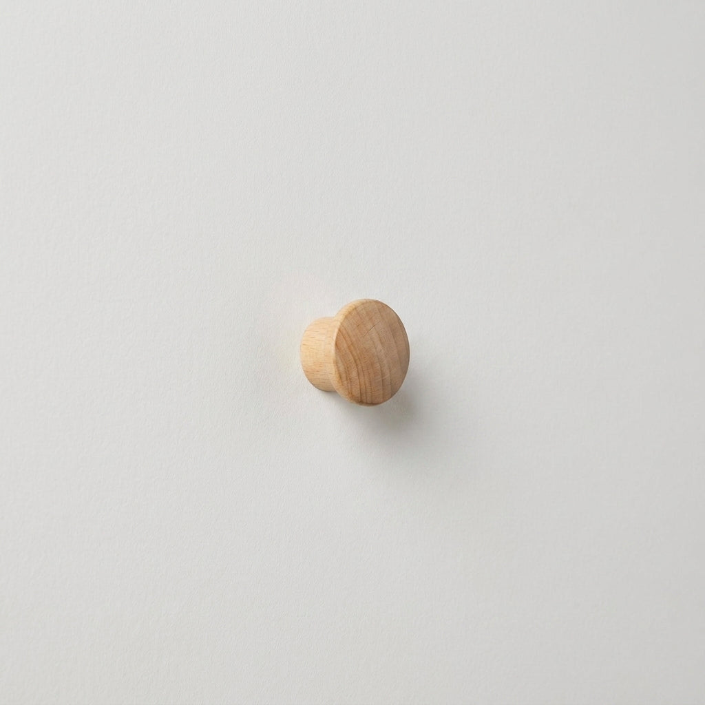 Round light natural wood peg hook, visible grain, side profile on white surface