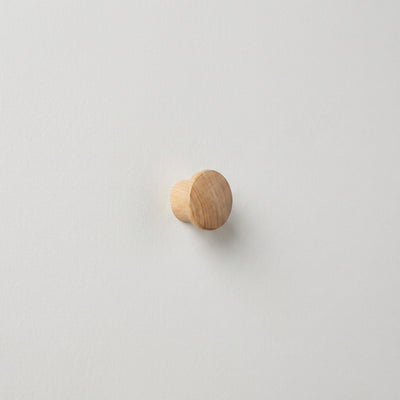 
                    
                      Round light natural wood peg hook, visible grain, side profile on white surface
                    
                  