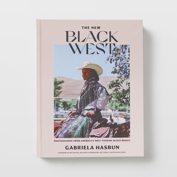 Chronicle Books The New Black West book, light peach cover featuring a Black rodeo rider in a cowboy hat, front view on…