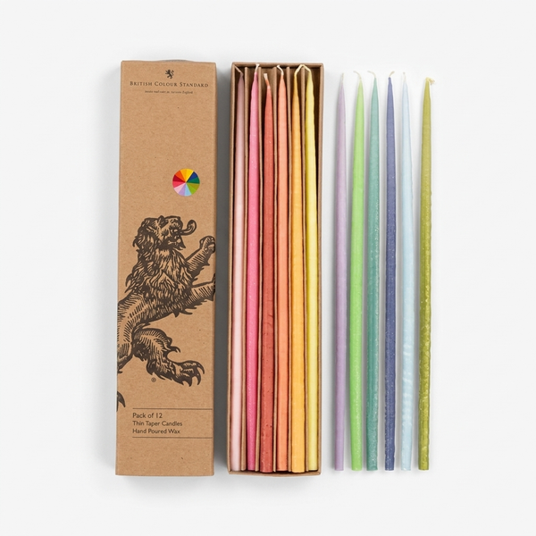 British Colour Standard Thin Rainbow Taper Candles, set of 12, pastel wax colors, flat lay view with open box on white.
