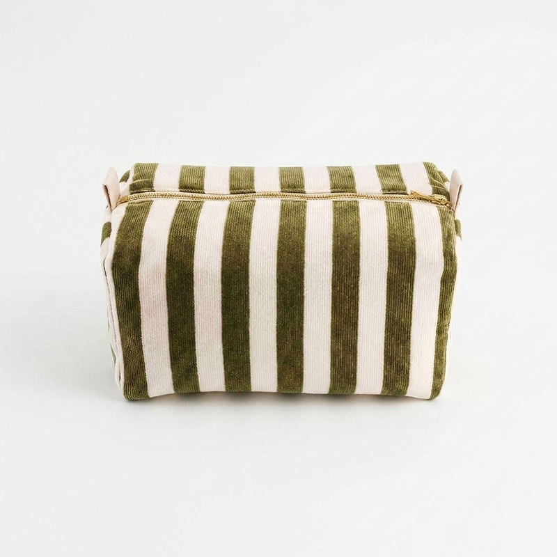 Rose in April Vic Toiletry Bag - Terry Olive studio product photo hanging from a wooden wall hook on a neutral off-white…