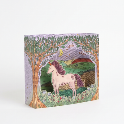 
                    
                      Twilight Unicorn die-cut greeting card, angled view, revealing layered illustration of a pink unicorn in a meadow at…
                    
                  