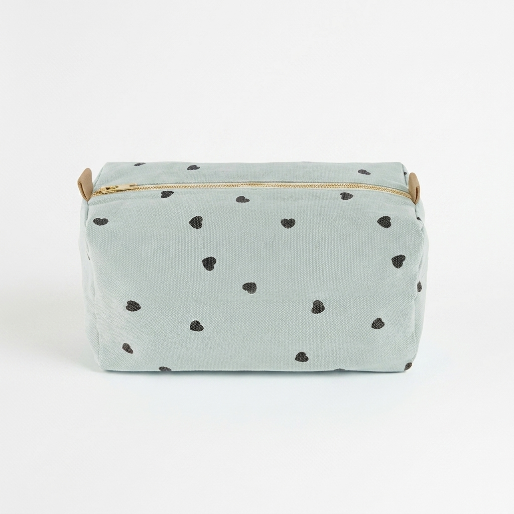 Rose in April Vic Toiletry Bag - Blue Hearts studio product photo hanging from a wooden wall hook on a neutral off-white…