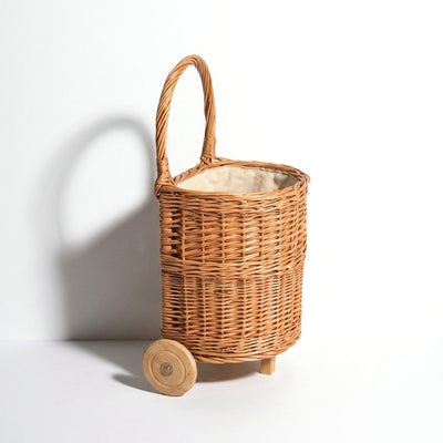 
                    
                      Egmont Wicker Shopping Caddy, natural woven willow basket with solid wood wheels, natural cotton fabric liner, front on…
                    
                  