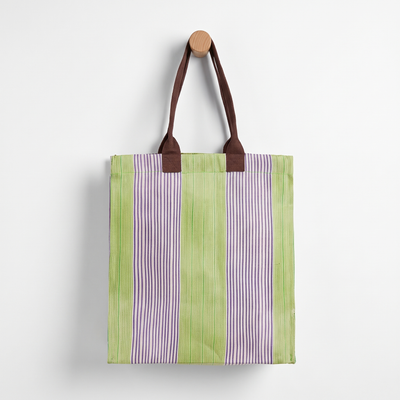 
                    
                      British Colour Standard Woven Market Tote - (Doge, Pearl & Grass) studio product photo hanging from a wooden wall hook on a…
                    
                  